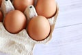 Eggs in a cardboard box. Open egg packaging, close-up Royalty Free Stock Photo