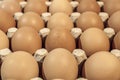 Eggs in carton package on a wooden table for baking, close up Royalty Free Stock Photo