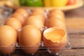 eggs of chicken and yolk with broken in plastic box on the wooden table Royalty Free Stock Photo