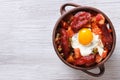 Eggs with chorizo, potatoes and tomatoes in a pot. top view Royalty Free Stock Photo