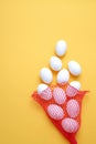 Eggs,Eggs come out of the net red bag.top view yellow background easter egg Royalty Free Stock Photo