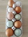 Eggs in different colours in paper box