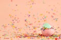 Eggs with easter theme in pink background, blue easter egg inside oter egg with confetti Royalty Free Stock Photo