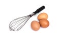 Eggs and eggbeater on white background