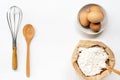 Eggs and flour on white table background. basic baking background. Royalty Free Stock Photo