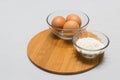 Eggs and flour on white table background. basic baking background. Royalty Free Stock Photo