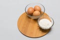 Eggs and flour on white table background. basic baking background. Royalty Free Stock Photo