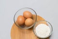 Eggs and flour on white table background. basic baking background. Royalty Free Stock Photo