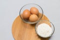 Eggs and flour on white table background. basic baking background. Royalty Free Stock Photo
