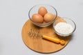 Eggs and flour on white table background. basic baking background. Royalty Free Stock Photo