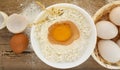 Eggs and flour on wooden table