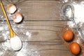 Eggs, flour on the wooden table. Retro whisk. Royalty Free Stock Photo