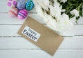Eggs, flowers and envelope with grey type on table