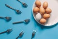 Eggs and forks, flat lay, oocyte fertilization, pregnancy, conception concept. Royalty Free Stock Photo