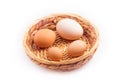 eggs - four chicken eggs of different sizes in a small wicker basket