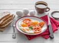 Eggs fried overeasy served on white plate Royalty Free Stock Photo