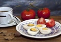 Cooked egg and tomato on a wooden table