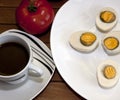 Cooked egg and tomato on a wooden table