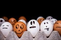 Eggs with funny expressions simulating human faces. Concept of ethnic diversity and moods Royalty Free Stock Photo