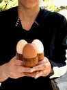 Eggs Held in Hands of an Lady in Egg Cup Royalty Free Stock Photo