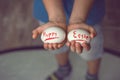 Eggs with the inscription Happy Easter the child holds in her hands in front of him