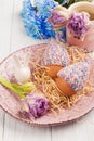 Eggs in knitted hats, flowers and decorative rabbit