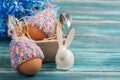 Eggs in knitted hats, flowers and decorative rabbit