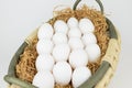 Eggs lay on hay in basket