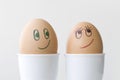 Close up of smiling faces drawn on two boiled eggs, love happiness relationship concept Royalty Free Stock Photo