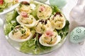 Eggs with mayonnaise stuffed with vegetable salad on Easter table