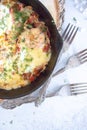 Eggs with mushrooms, bacon, tomato and cheese in a pan Royalty Free Stock Photo