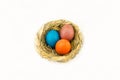 Eggs in a nest of wicker straw on a white background Royalty Free Stock Photo