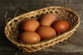 Eggs in the package on brown wwoden background. Royalty Free Stock Photo