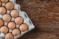 Eggs in the package on a wooden background Royalty Free Stock Photo