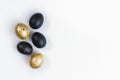 Eggs painted gold and black on white background. Minimal Easter concept. Golden luxury backdrop Royalty Free Stock Photo