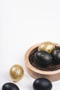 Eggs painted gold and black. Overhead of nest containing egg. Minimal Easter concept with copy space for text. Royalty Free Stock Photo