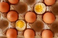 Eggs in paper tray. one soft-boiled. view from top. Boiled halve Royalty Free Stock Photo