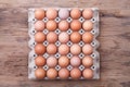 Eggs in paper tray on wood table Royalty Free Stock Photo