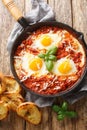 Eggs in Purgatory is an easy Italian dish served with lots of crusty bread for dipping closeup. Vertical top view Royalty Free Stock Photo