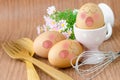 Eggs sleep with Expression Face in white cup and flower.