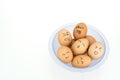 Eggs with smiling happy faces on plastic bowl, isolated on white background Royalty Free Stock Photo