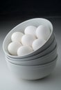 Eggs in stacked white bowls Royalty Free Stock Photo
