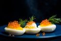 Eggs stuffed with red caviar tasty and healthy serving as in a restaurant on a blue plate