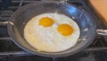 Eggs sunny side up on a hot pan