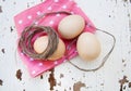 Eggs on tablecloth over wooden background