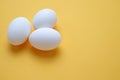 Three White egg on the yellow background in center,Eggs,