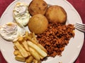 Eggs and 'tortos con picadillo' (porc meat and corn fried bread) with potatoes, typical meal in Asturias