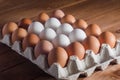 Eggs in a tray on a wooden table Royalty Free Stock Photo