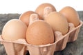 Eggs in a tray on a wooden table. Royalty Free Stock Photo