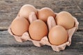 Eggs in a tray on a wooden table. Royalty Free Stock Photo